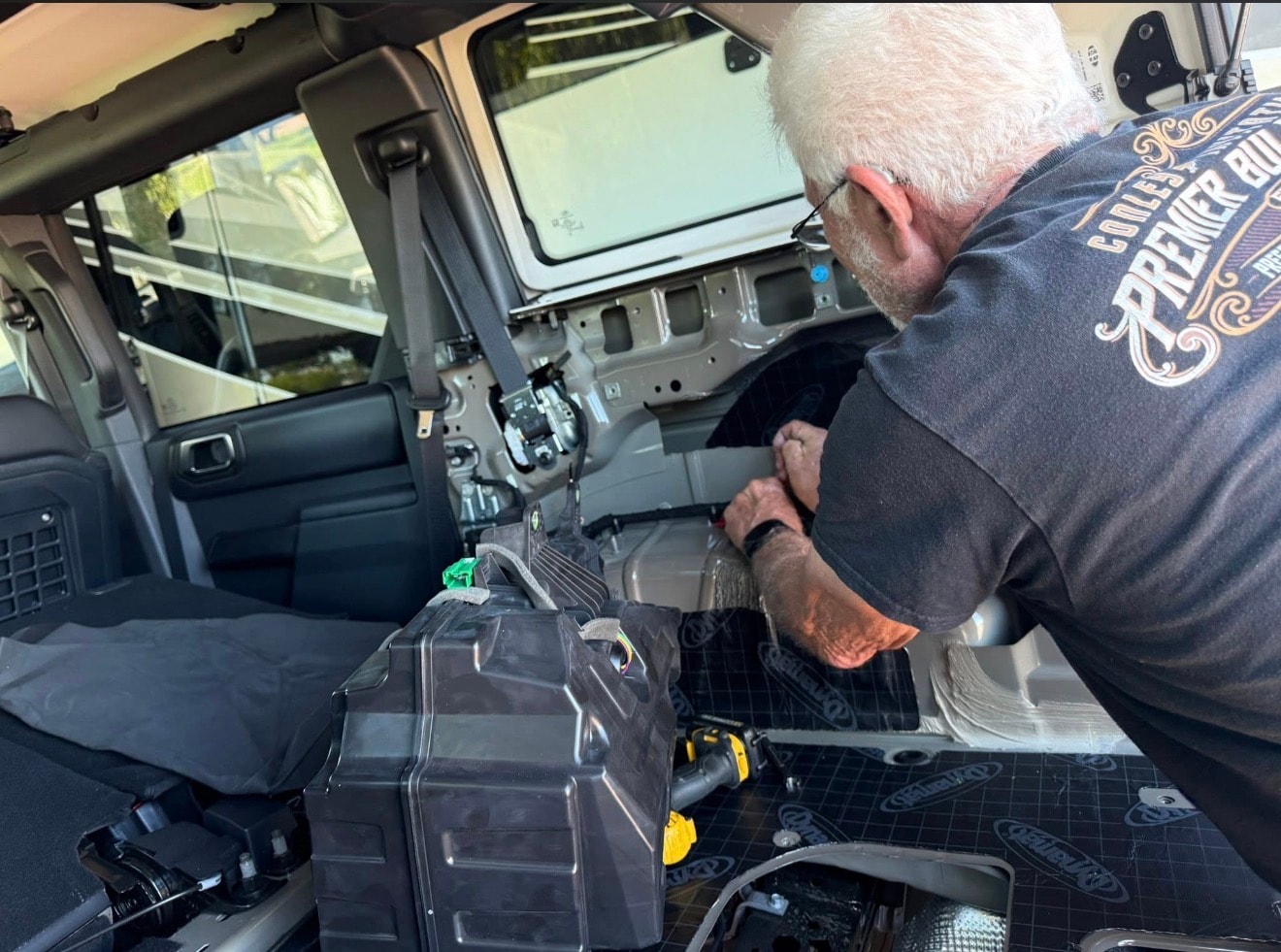 Technician installing Bronco interior sound deadening
